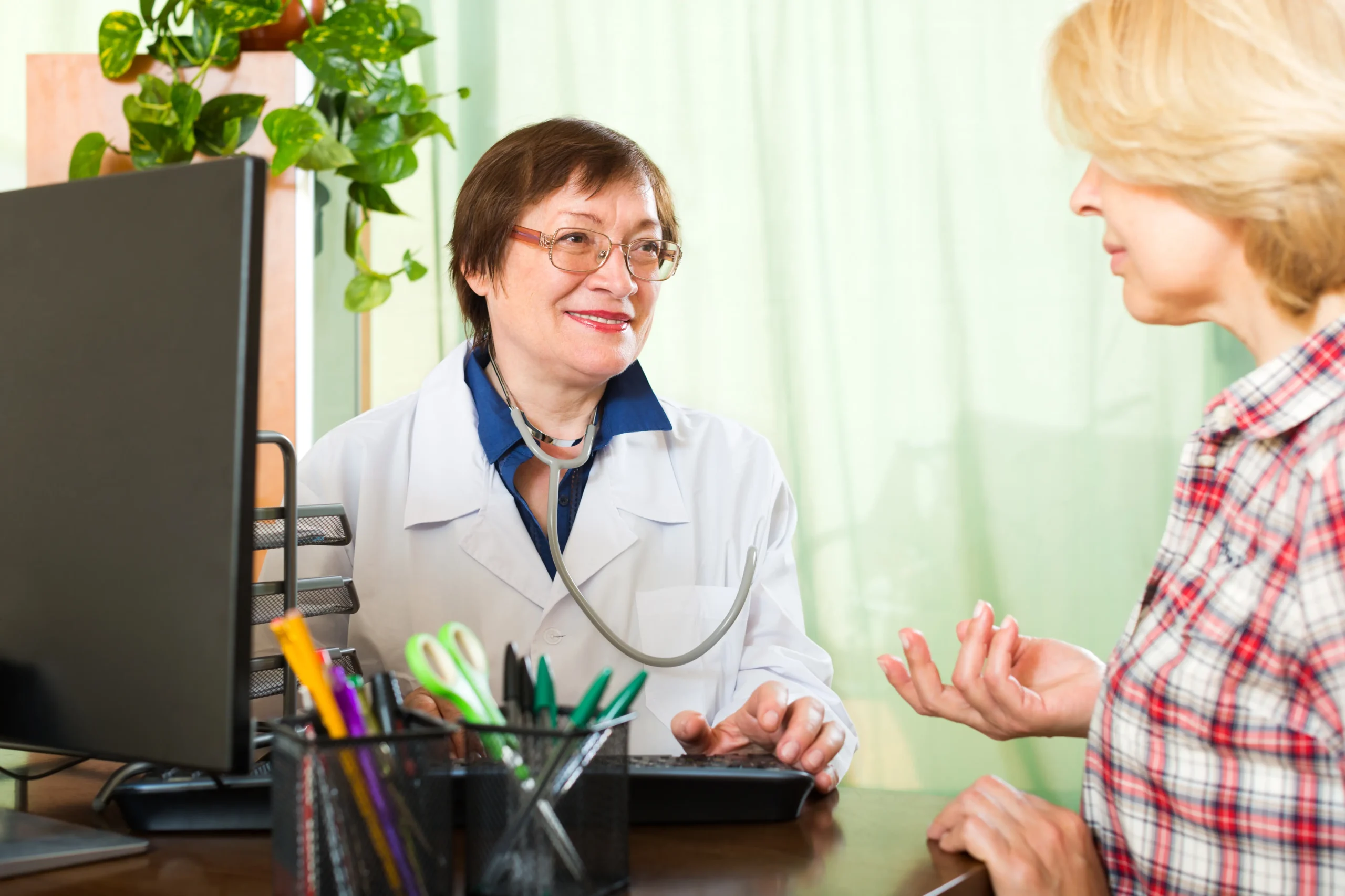Doctor explaining colonoscopy recovery instructions to a patient during a consultation